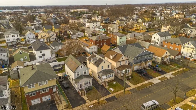an aerial view of residential houses with yard