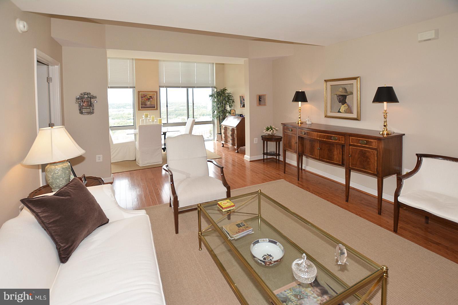 11990 Market Street, Unit 1614 Reston, VA 20190 - Photo 5 of 38 LIVING ROOM WITH HARDWOOD FLOORS & HIGH CEILING