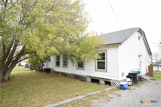 a view of a house with a chairs and table in a patio
