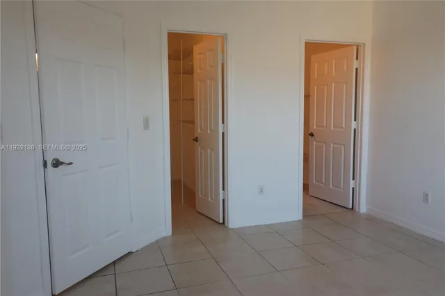 a room with stainless steel appliances a refrigerator and a microwave