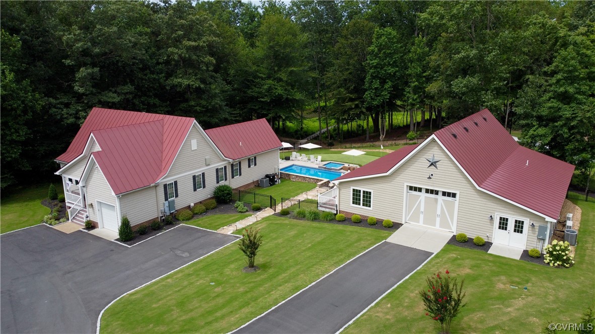 a aerial view of a house with swimming pool yard and outdoor seating