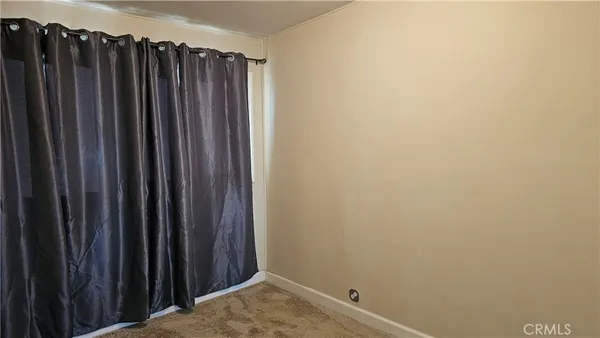a view of a hallway with wooden floor and closet