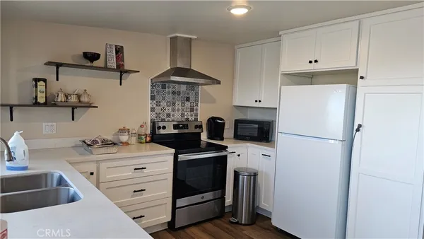 a kitchen with stainless steel appliances a refrigerator and a stove