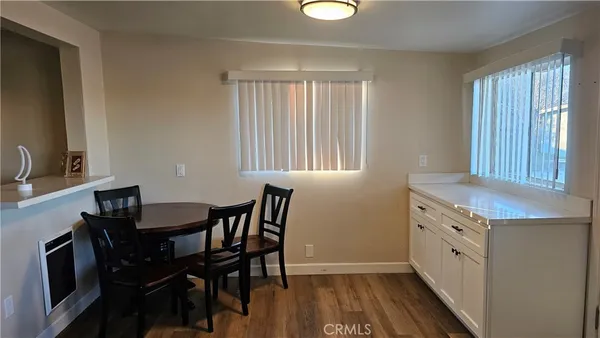 a view of a dining room with furniture and a chandelier