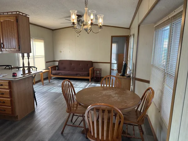 a view of a dining room with furniture and chandelier