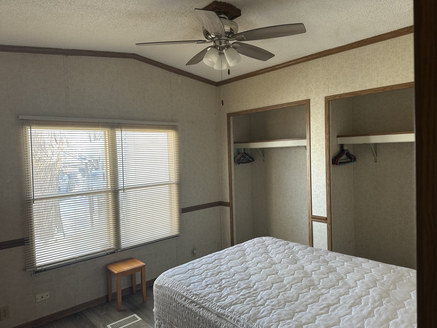 8800 South Harlem Avenue, Unit 1127 Bridgeview, IL 60455 - Photo 6 of 9 a bedroom with a bed and a chandelier