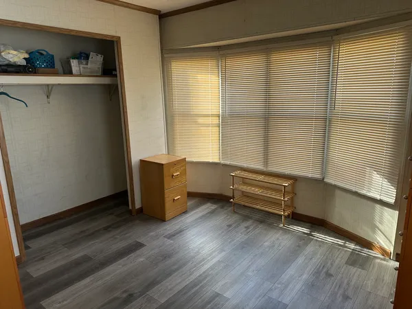 a room with lounge chair and a window