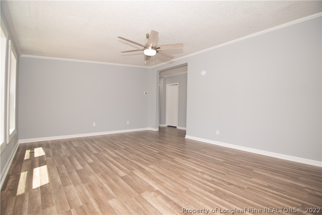 516 West Northpoint Road Spring Lake, NC 28390 - Photo 16 of 41 an empty room with wooden floor fan and window