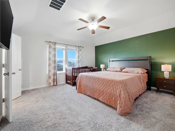 a bedroom with a bed and a chandelier