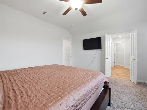 a bedroom with a bed and a flat screen tv