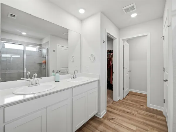 a bathroom with a double vanity sink and mirror