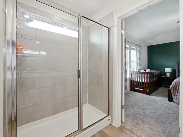 a bathroom with a glass shower door