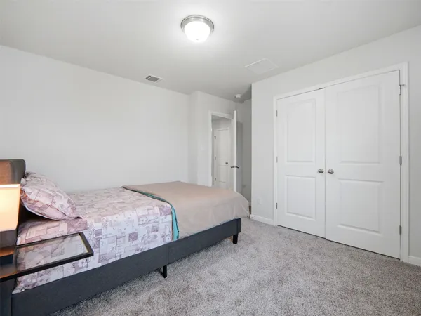 a bedroom with a bed and hallway