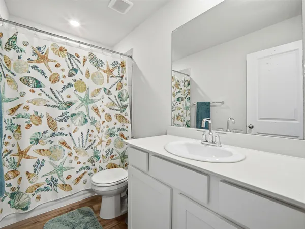 a bathroom with a sink toilet and shower