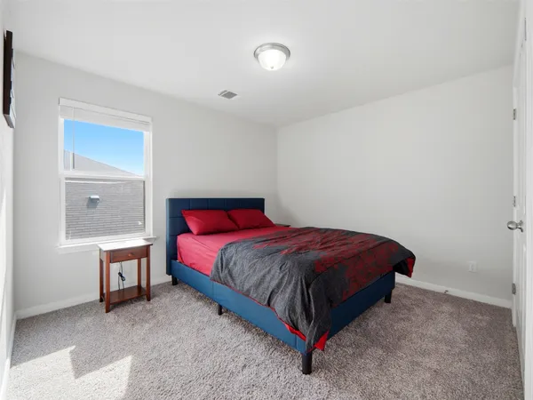 a spacious bedroom with a bed and a table