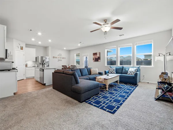 a kitchen with a stove a sink a dining table and chairs