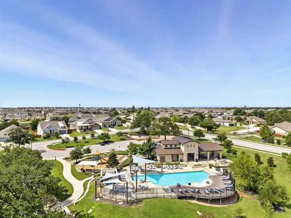 an aerial view of residential houses with outdoor space