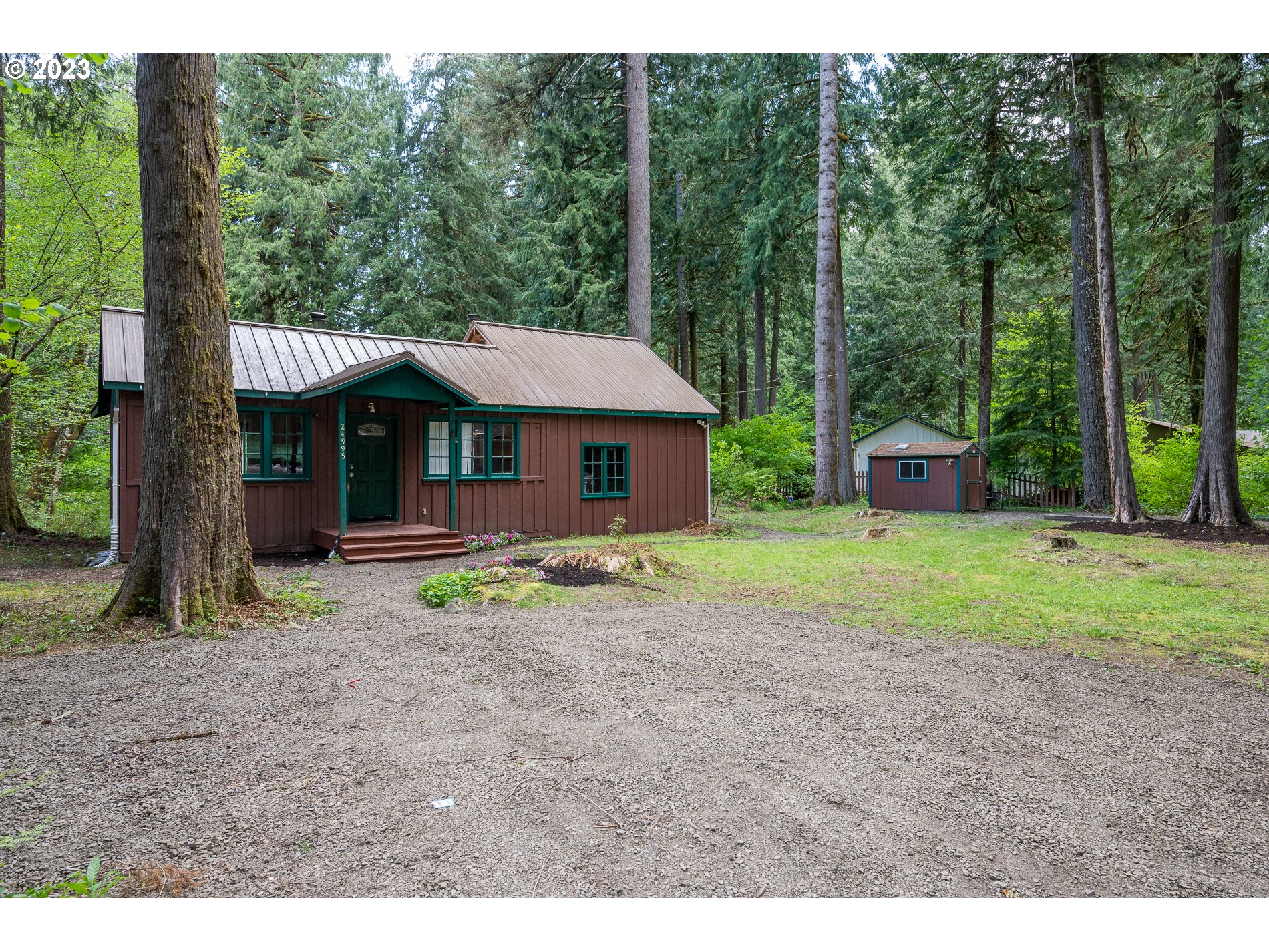 24995 East Old Smokey Road Rhododendron, OR 97049 - Photo 1 of 39 a view of a house with a yard and large tree