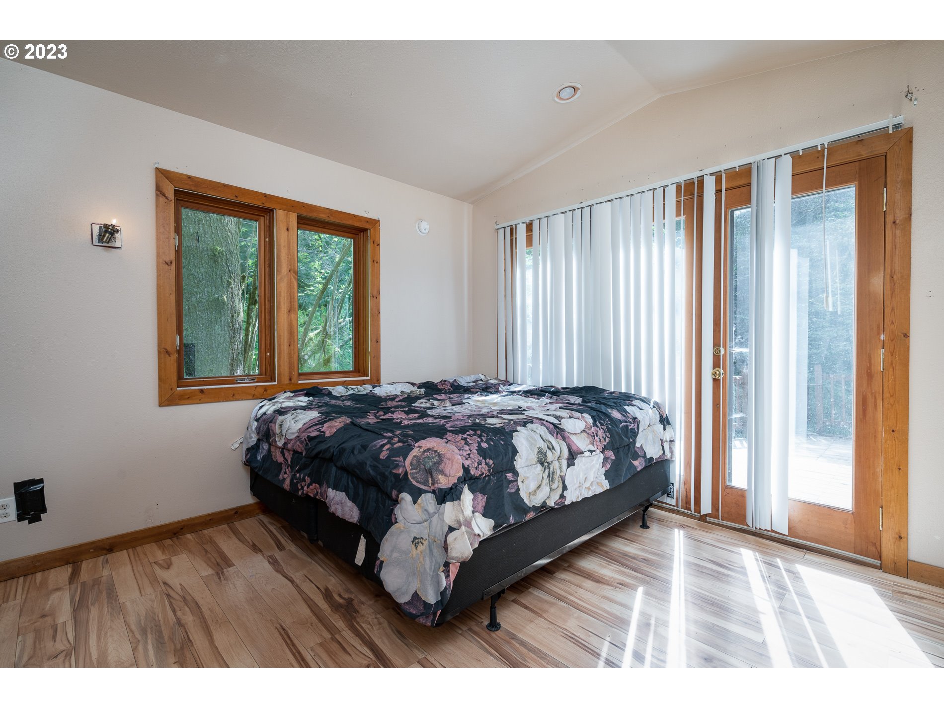 24995 East Old Smokey Road Rhododendron, OR 97049 - Photo 13 of 39 a bed sitting in a spacious bedroom next to a window