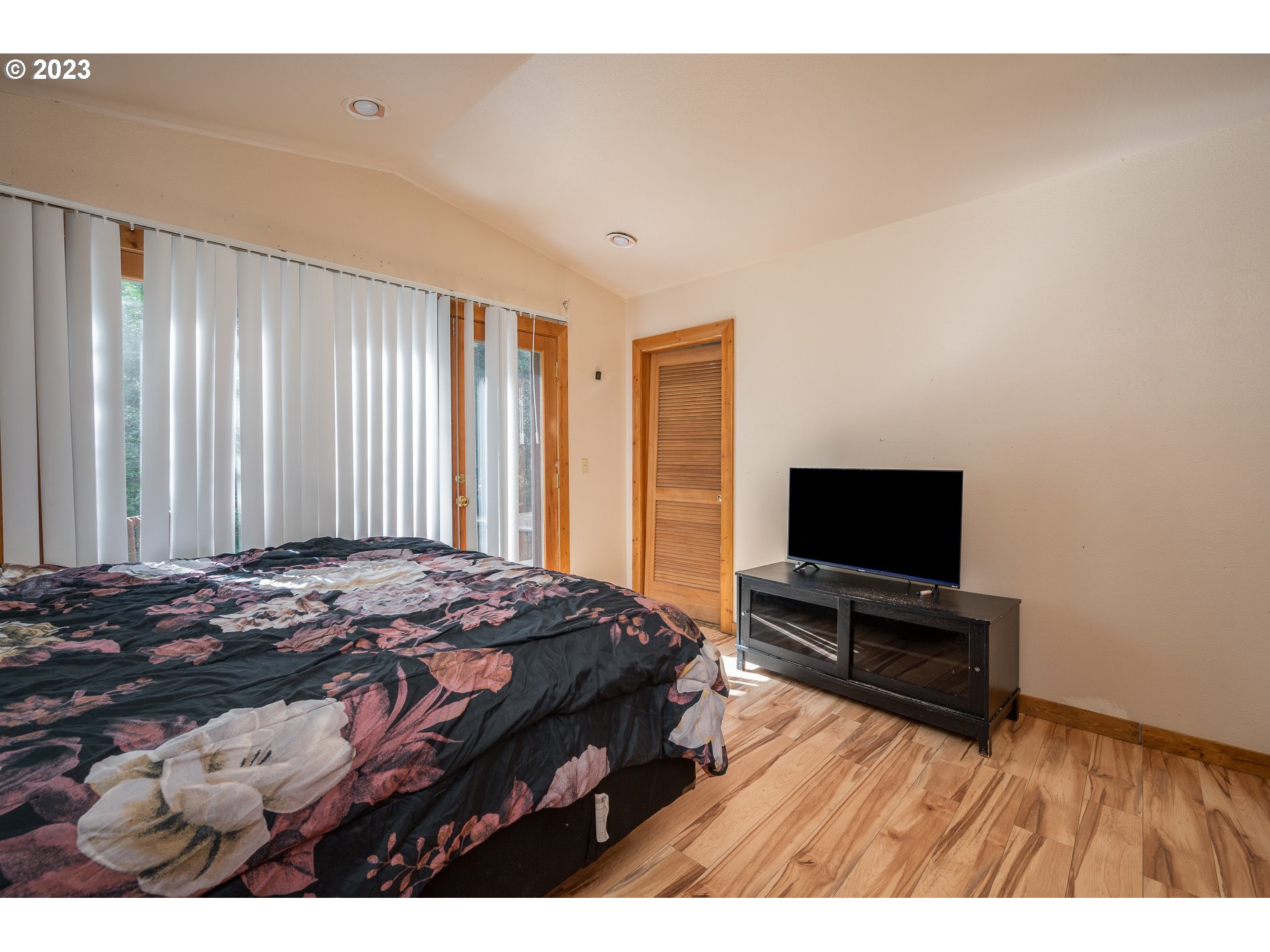 24995 East Old Smokey Road Rhododendron, OR 97049 - Photo 14 of 39 a bedroom with a bed and a flat screen tv