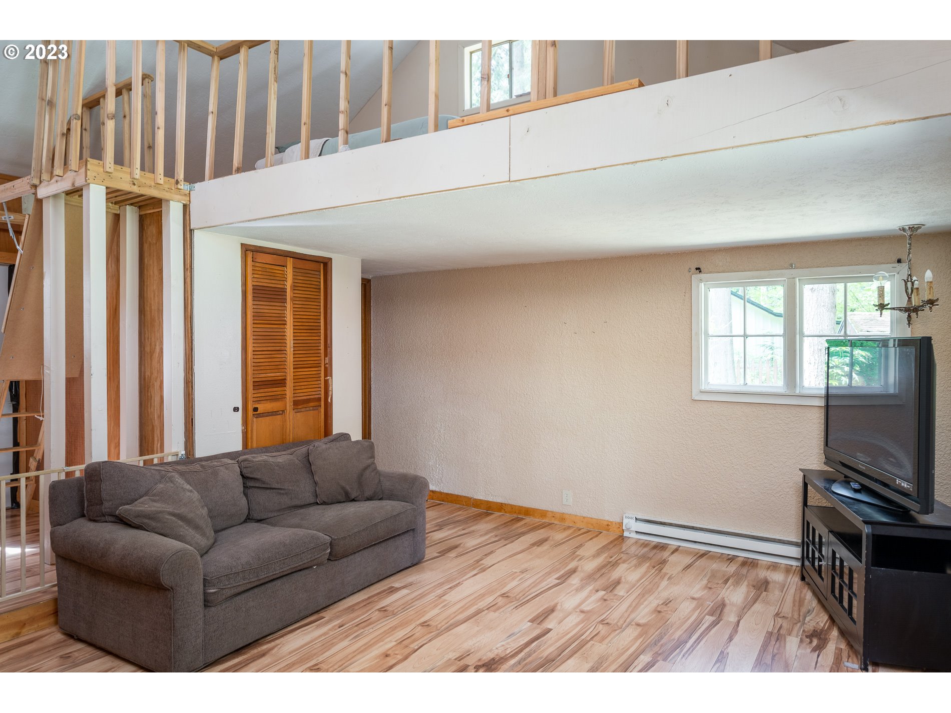 24995 East Old Smokey Road Rhododendron, OR 97049 - Photo 19 of 39 a living room with furniture a flat screen tv and a window
