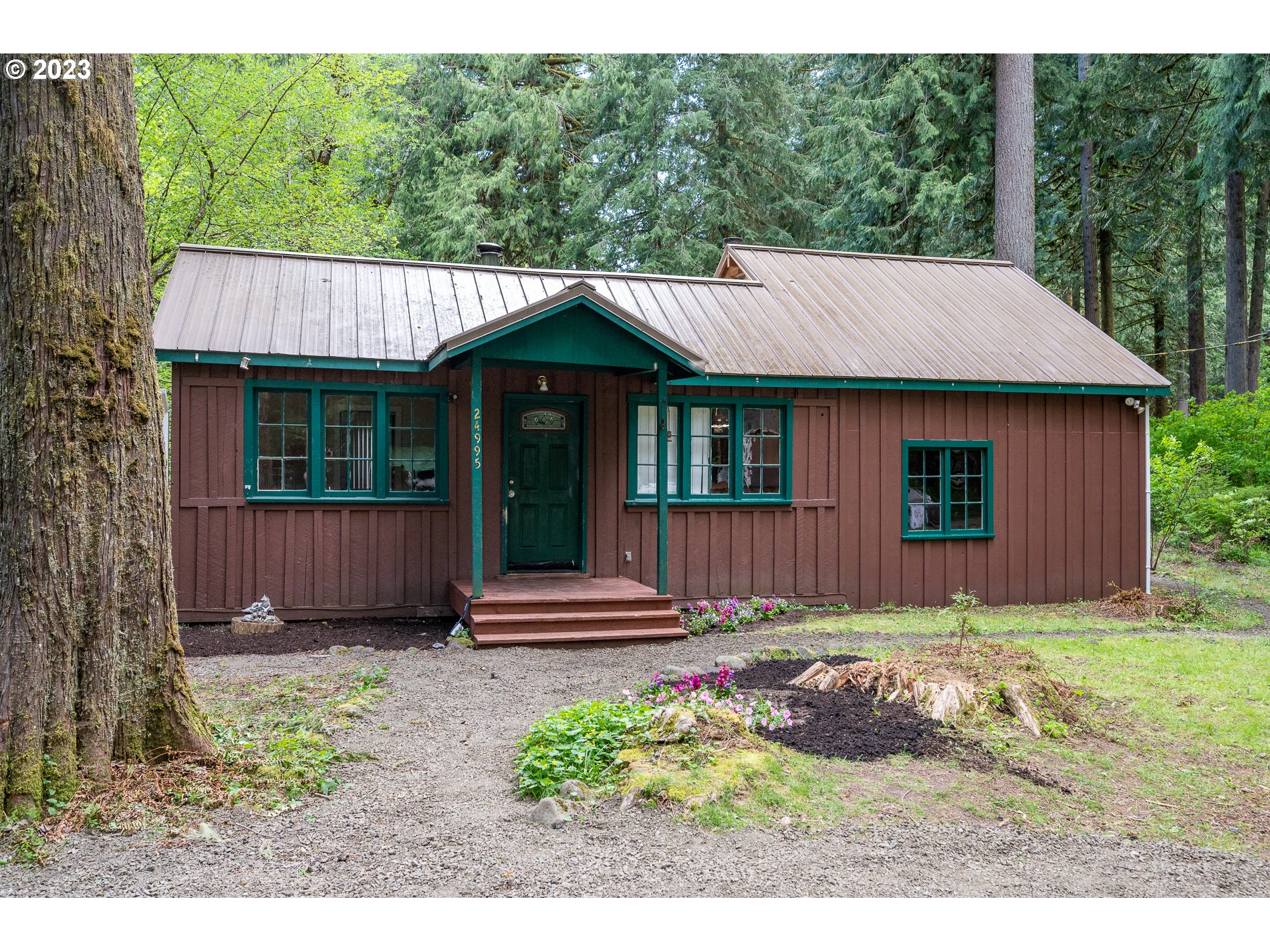 24995 East Old Smokey Road Rhododendron, OR 97049 - Photo 5 of 39 a view of a house with a yard and wooden fence