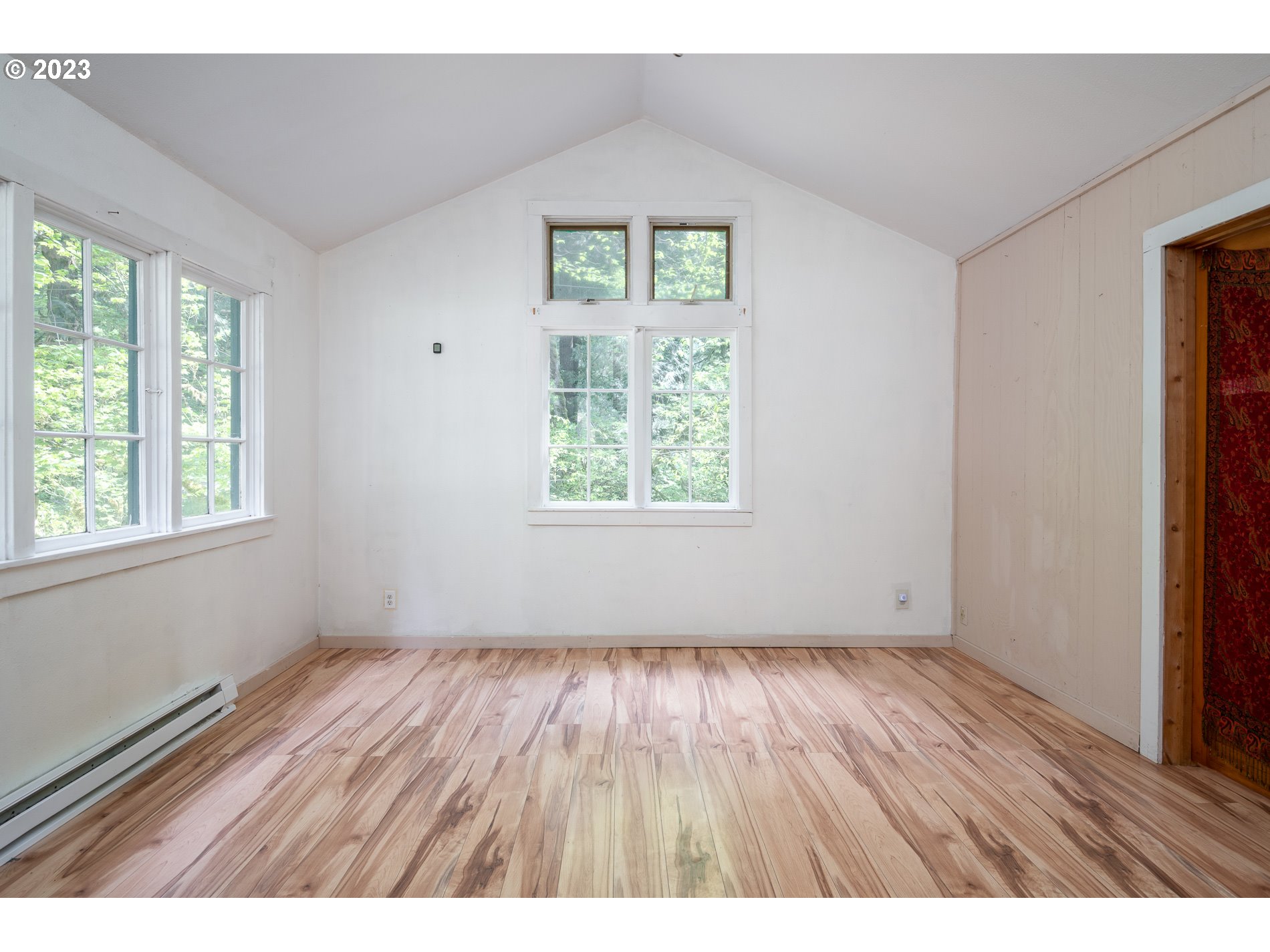 24995 East Old Smokey Road Rhododendron, OR 97049 - Photo 10 of 39 an empty room with wooden floor and windows