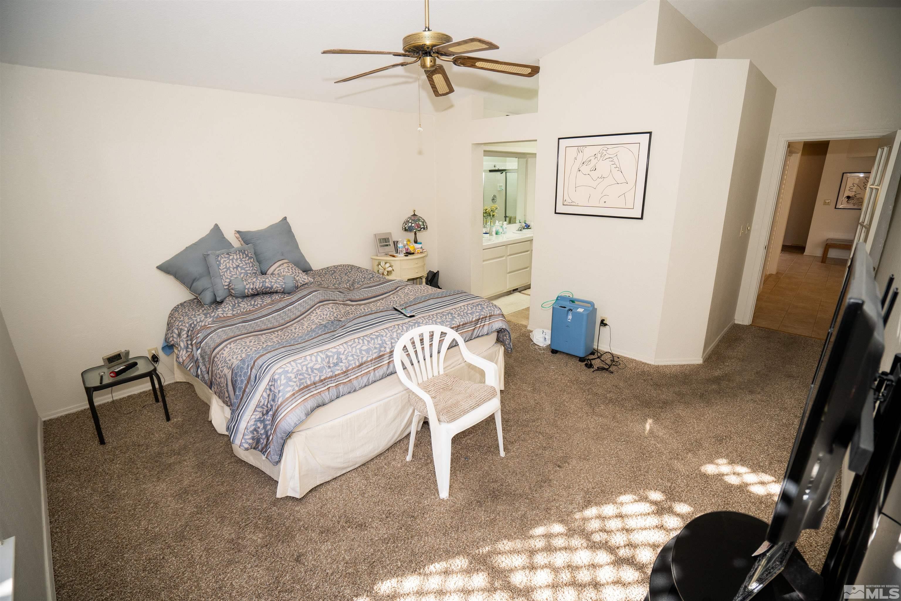 6346 Golden Creek Road Reno, NV 89519 - Photo 8 of 25 a bedroom with a bed and a chandelier