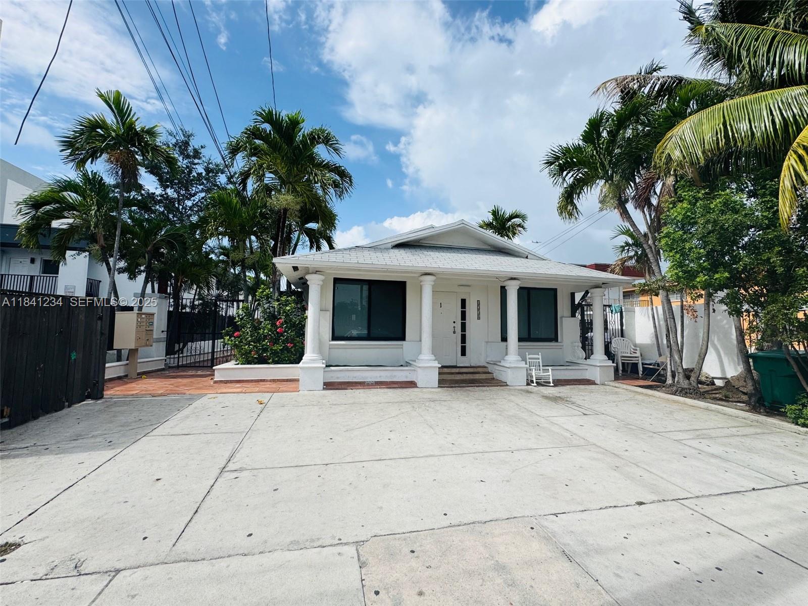 1238 Southwest 4th Street Miami, FL 33135 - Photo 14 of 27 a patio with a table and chairs and potted plants