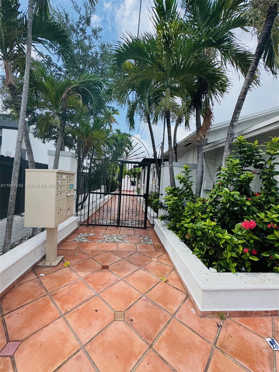1238 Southwest 4th Street Miami, FL 33135 - Photo 15 of 27 a view of a backyard with potted plants and large trees