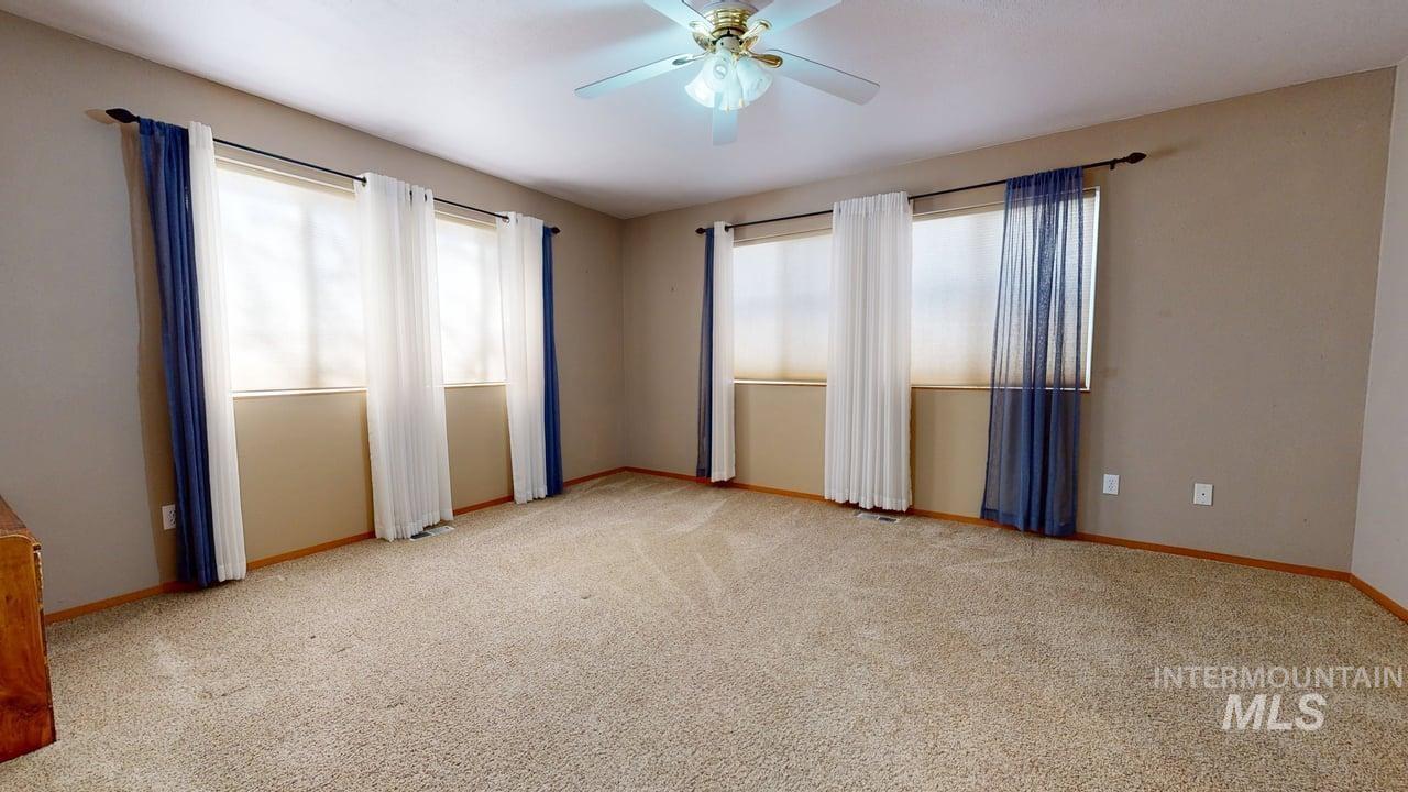 2794 9th Avenue Clarkston, WA 99403 - Photo 15 of 34 Empty room with light colored carpet and ceiling fan