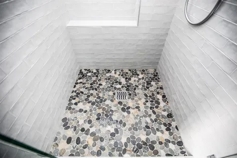 a bathroom with a bathtub and shower