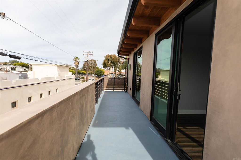 1136 South Coast Highway 101 Encinitas, CA 92024 - Photo 4 of 18 a view of a hallway with wooden floor