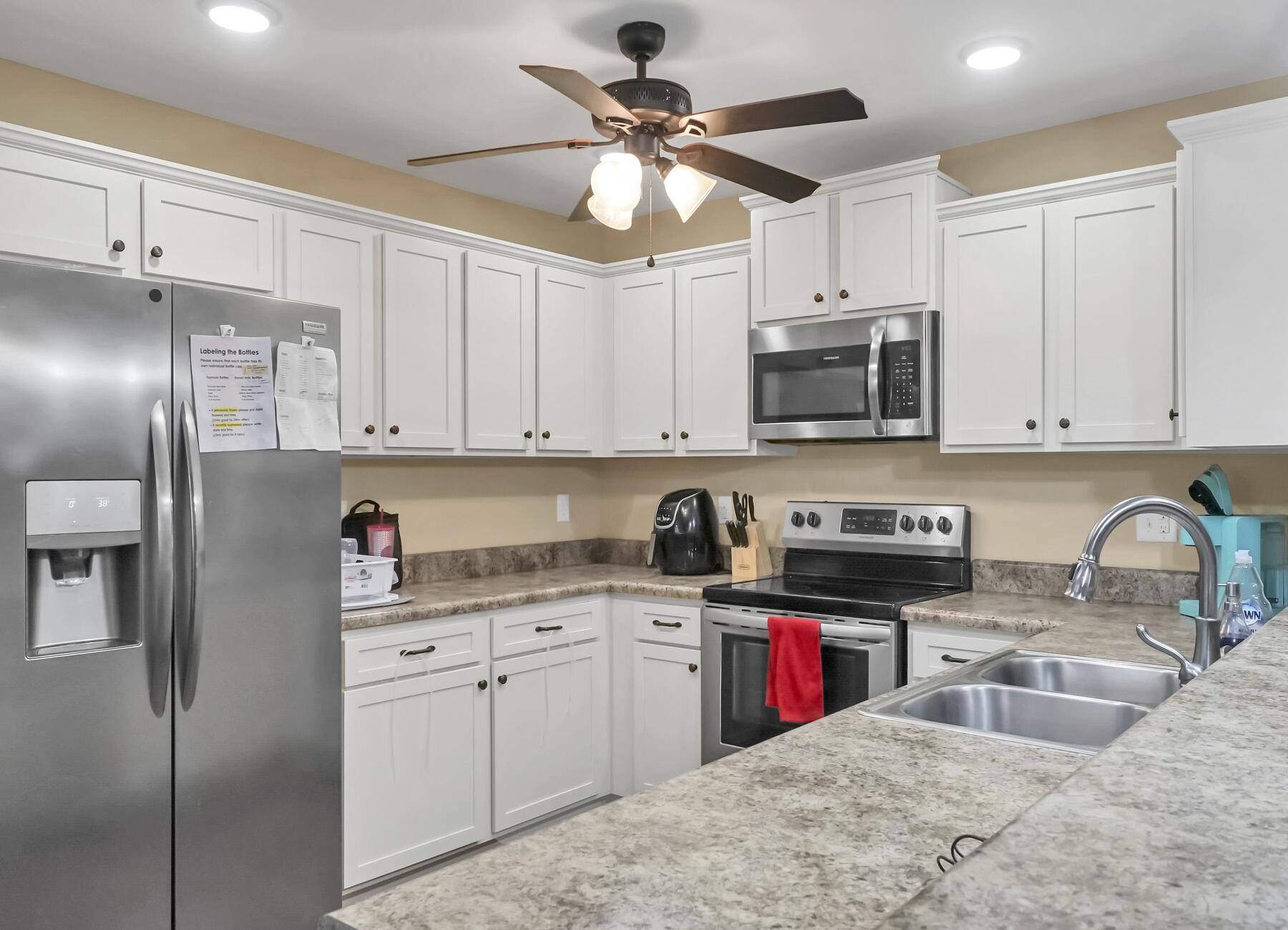 220 Wainwright Drive Crestview, FL 32539 - Photo 20 of 56 a kitchen with stainless steel appliances granite countertop a sink a stove a refrigerator cabinets and a refrigerator