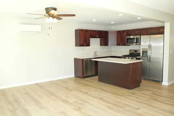 a kitchen with stainless steel appliances granite countertop a sink and a refrigerator