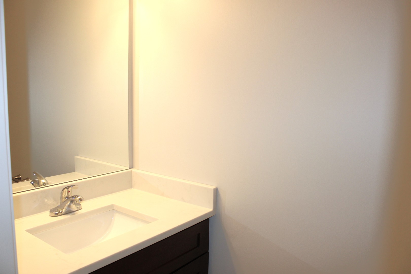 107 East Division Street, Unit 107 Manteno, IL 60950 - Photo 6 of 13 a bathroom with a sink and a mirror