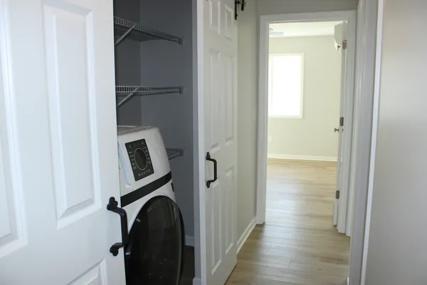 a view of a hallway with washer and dryer