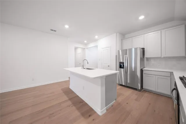a kitchen with a sink and a stove top oven