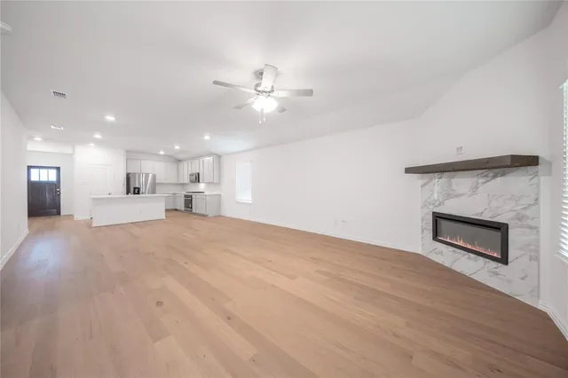 a kitchen with stainless steel appliances granite countertop a white stove top oven and white cabinets