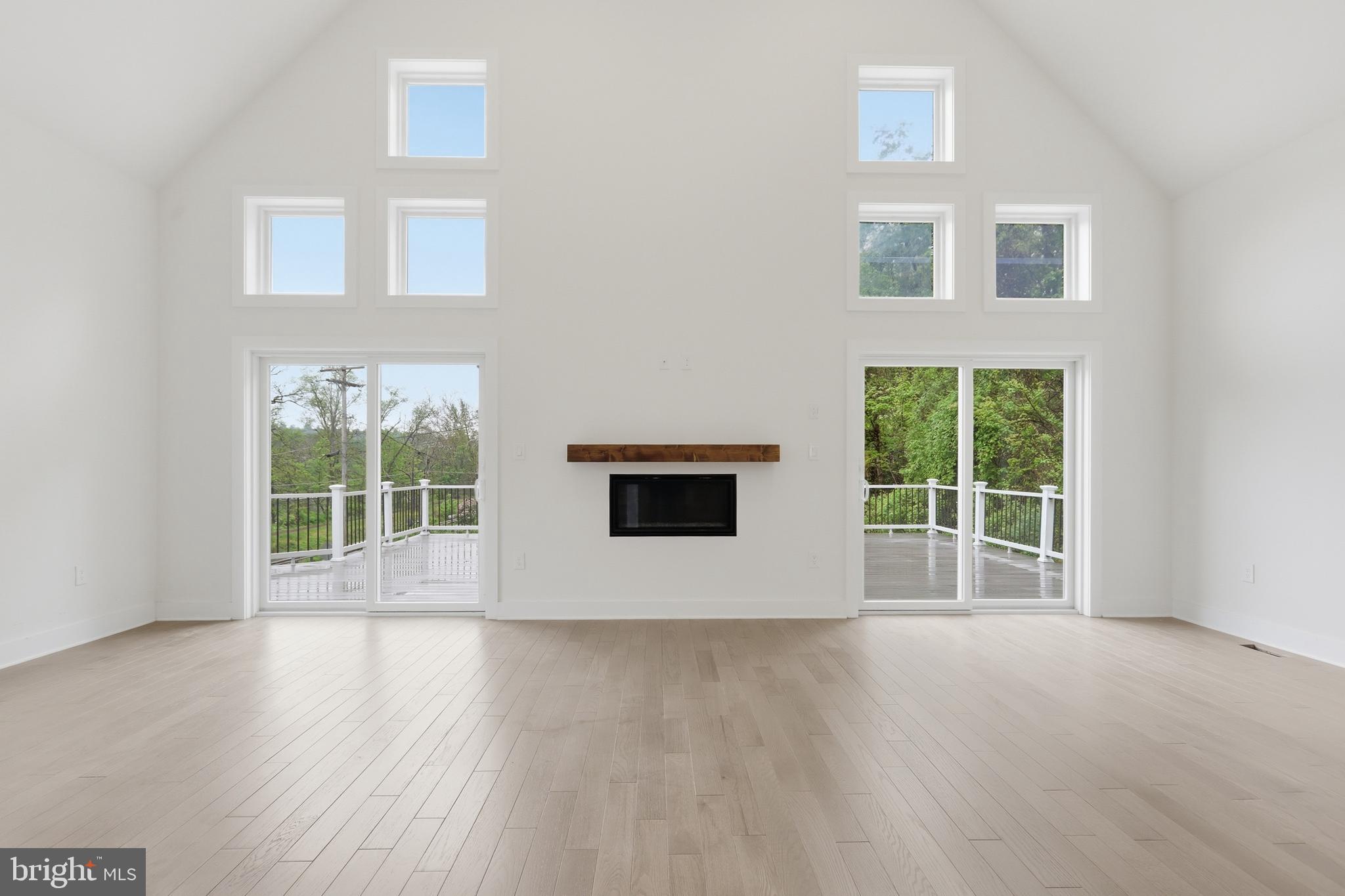 759 River Road Erwinna, PA 18920 - Photo 11 of 46 an empty room with wooden floor and windows