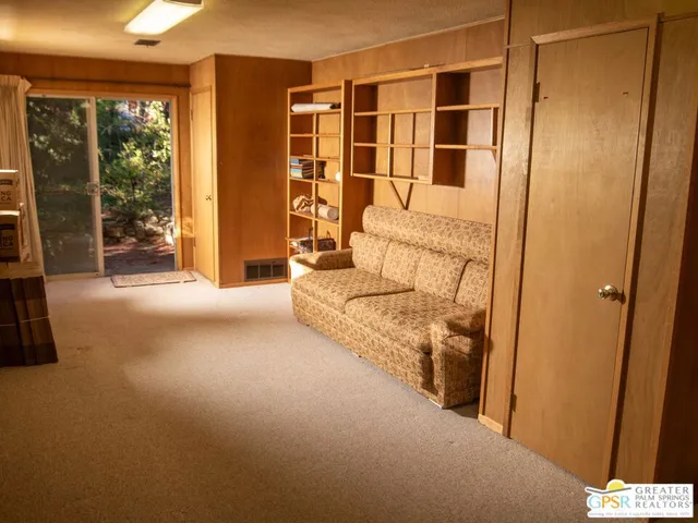 a living room with a bed and large window
