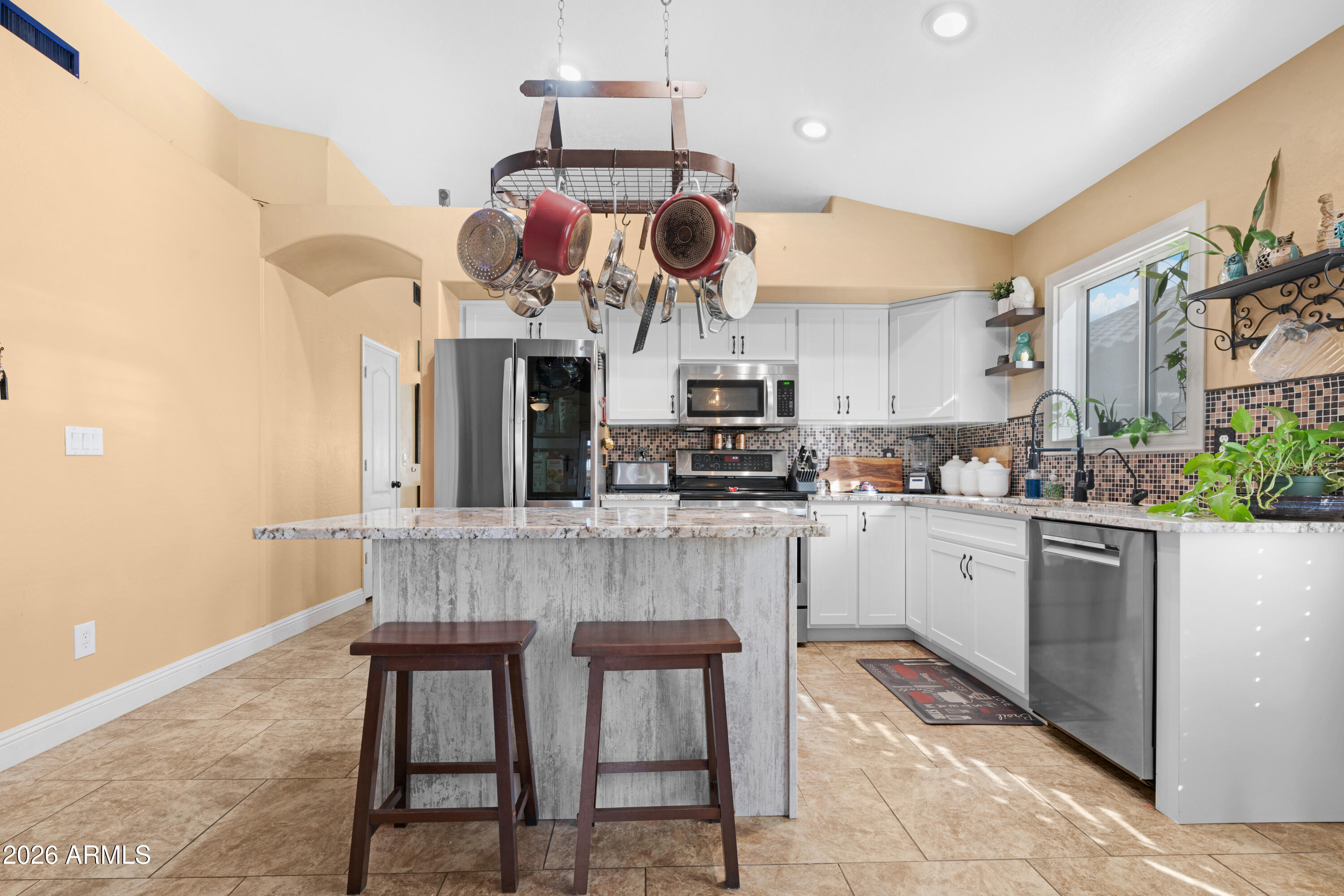 1513 West Shellfish Drive Gilbert, AZ 85233 - Photo 12 of 35 a kitchen with stainless steel appliances granite countertop a sink and cabinets