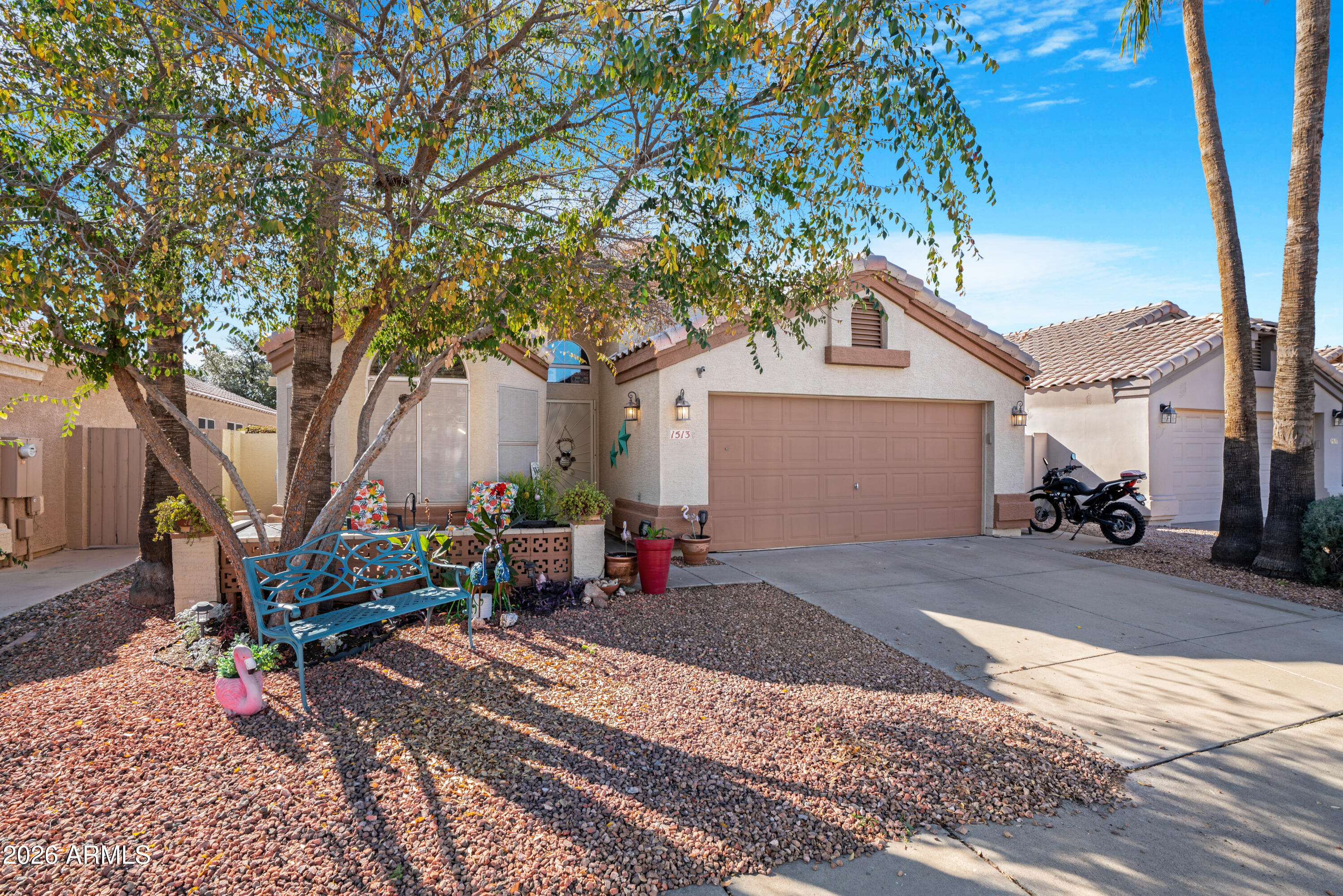 1513 West Shellfish Drive Gilbert, AZ 85233 - Photo 3 of 35 a view of a patio with table and chairs and a tree
