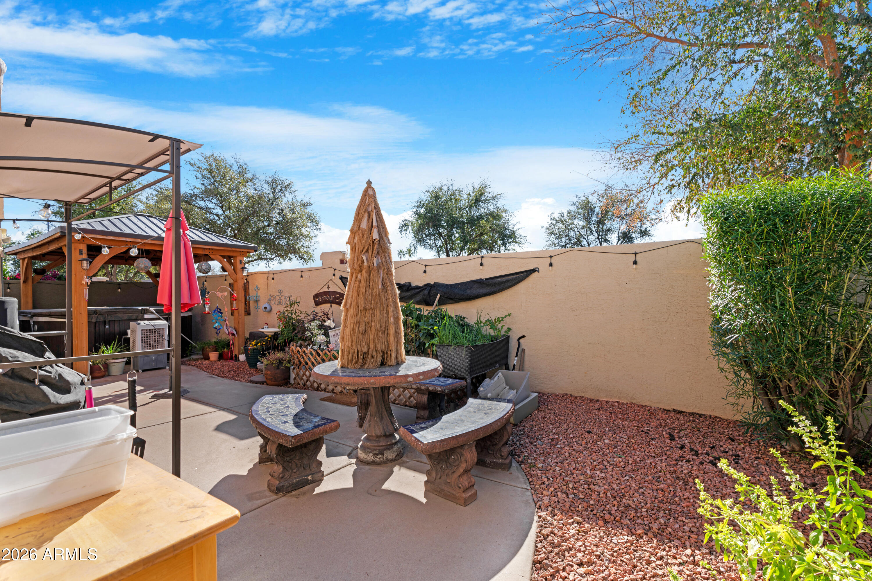 1513 West Shellfish Drive Gilbert, AZ 85233 - Photo 34 of 35 a view of a patio with couches and table and chairs under an umbrella
