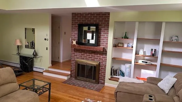 a living room with furniture flat screen tv and a fireplace