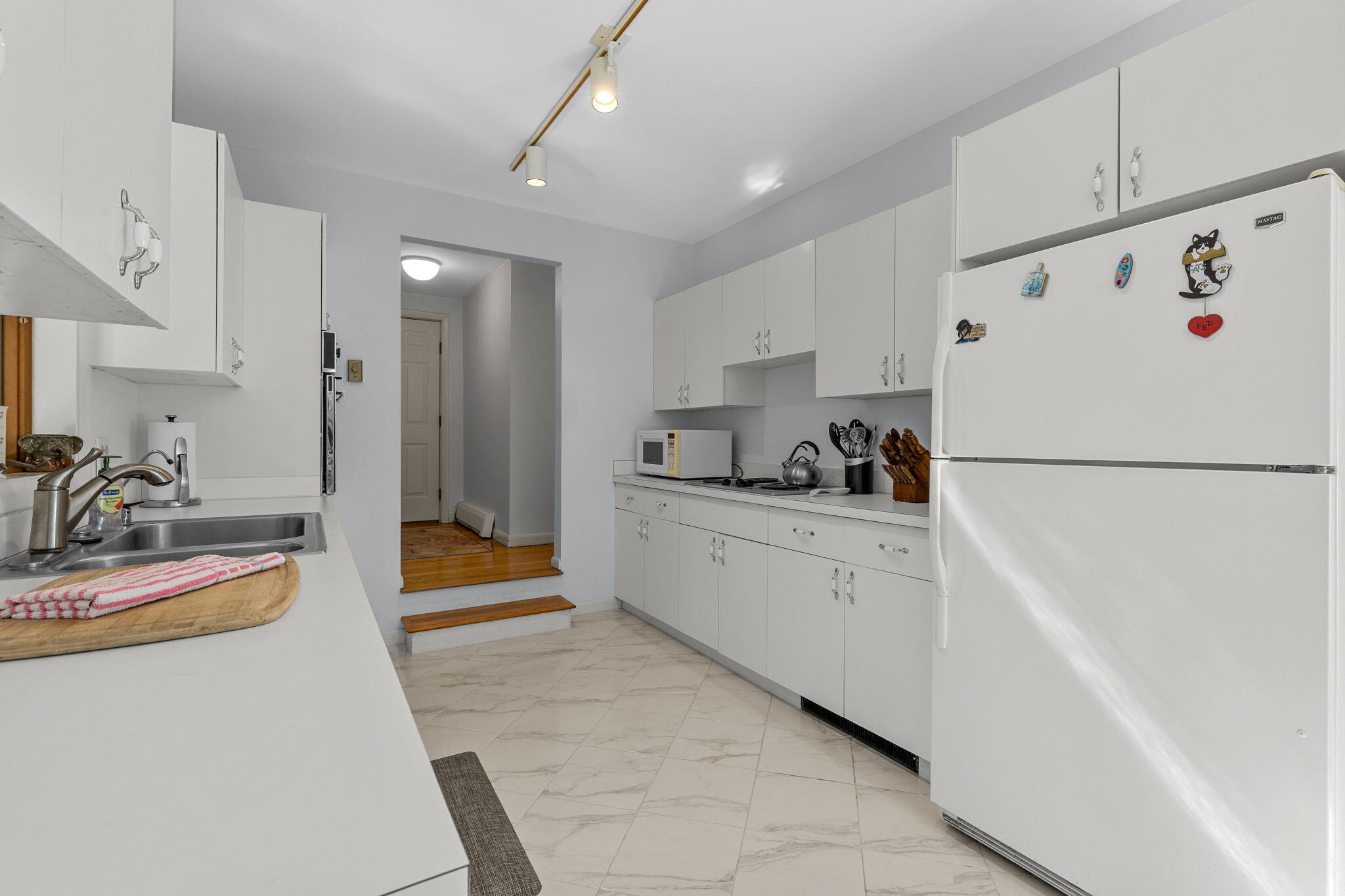 25 Twin Rocks Drive Eastham, MA 02642 - Photo 20 of 61 a kitchen with white cabinets and refrigerator
