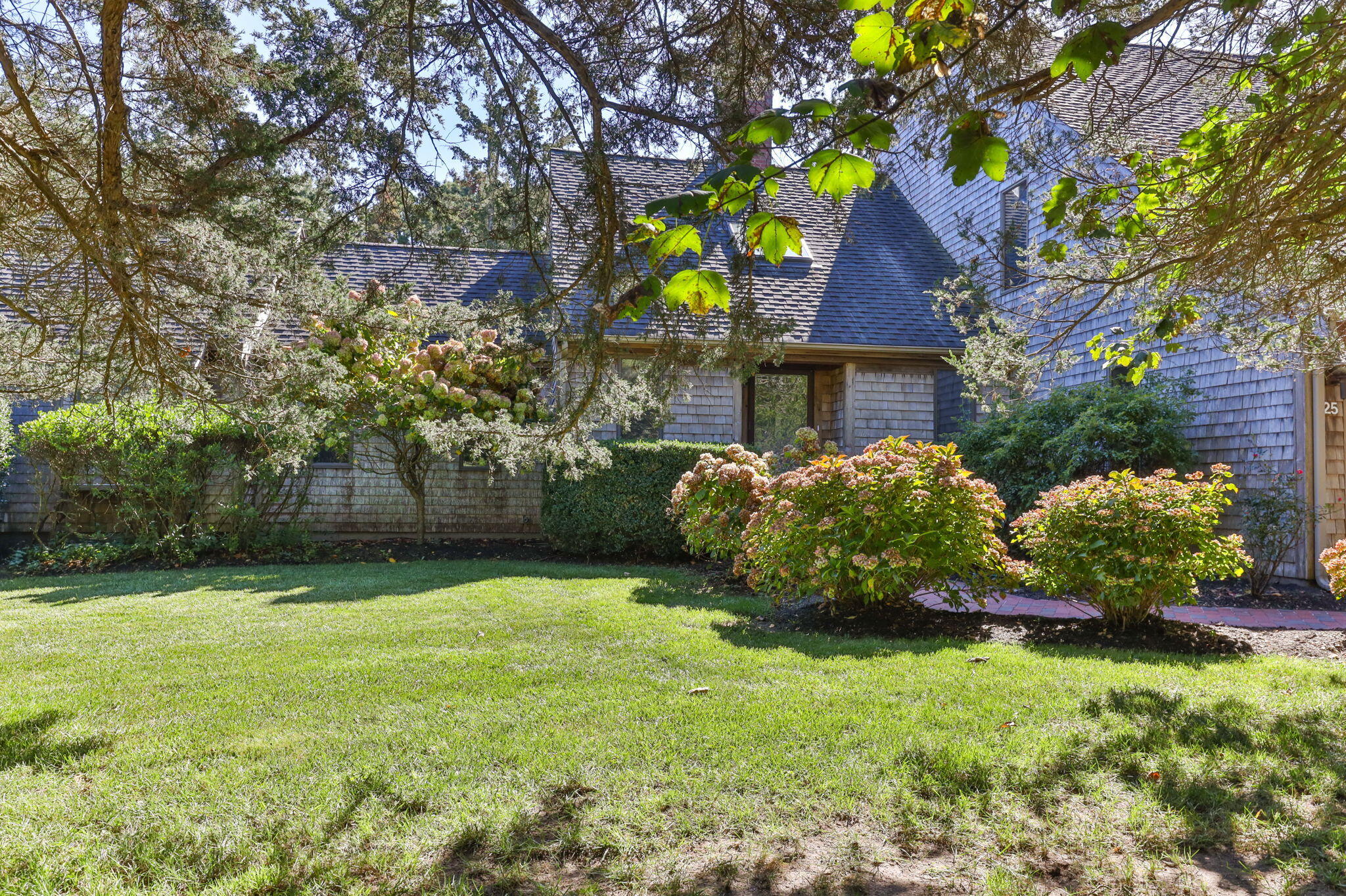 25 Twin Rocks Drive Eastham, MA 02642 - Photo 2 of 61 a front view of a house with garden