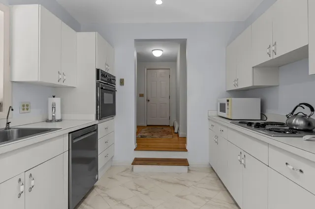 a living room with furniture windows and a table