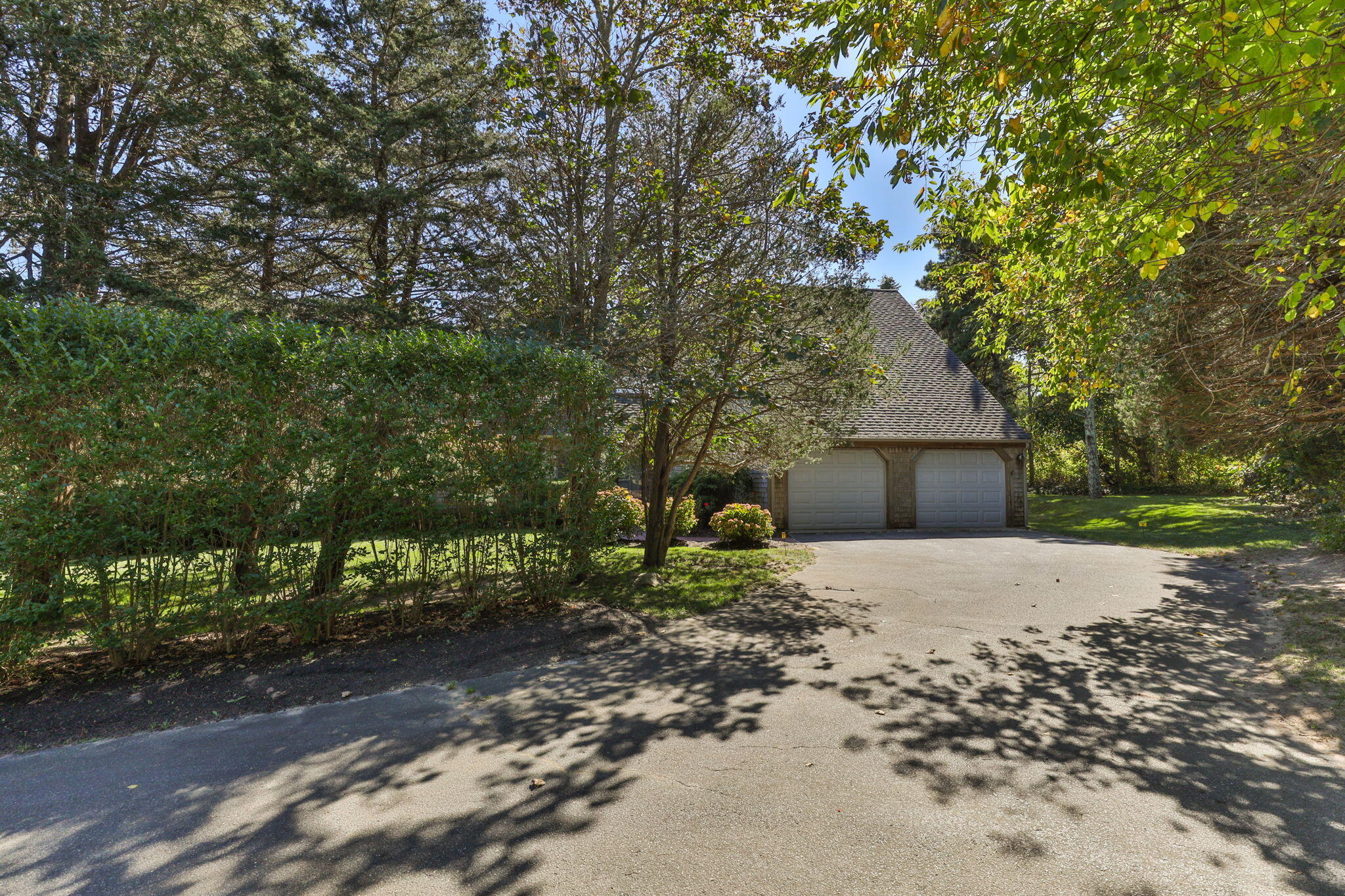25 Twin Rocks Drive Eastham, MA 02642 - Photo 3 of 61 a front view of a house with a yard and garage