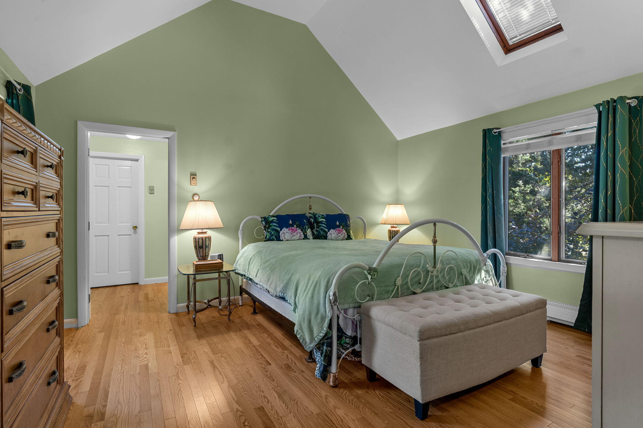 25 Twin Rocks Drive Eastham, MA 02642 - Photo 31 of 61 a bedroom with a bed and a lamp on dresser with wooden floor